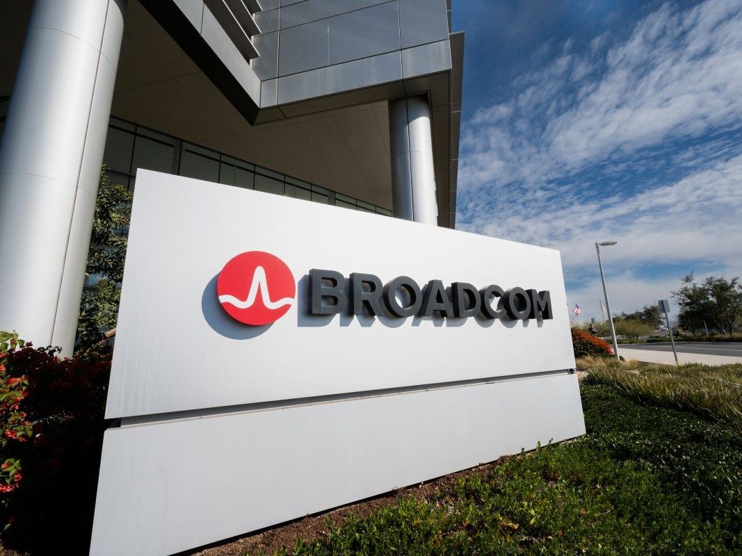 A Broadcom campus sign outside the company's offices under a blue sky.